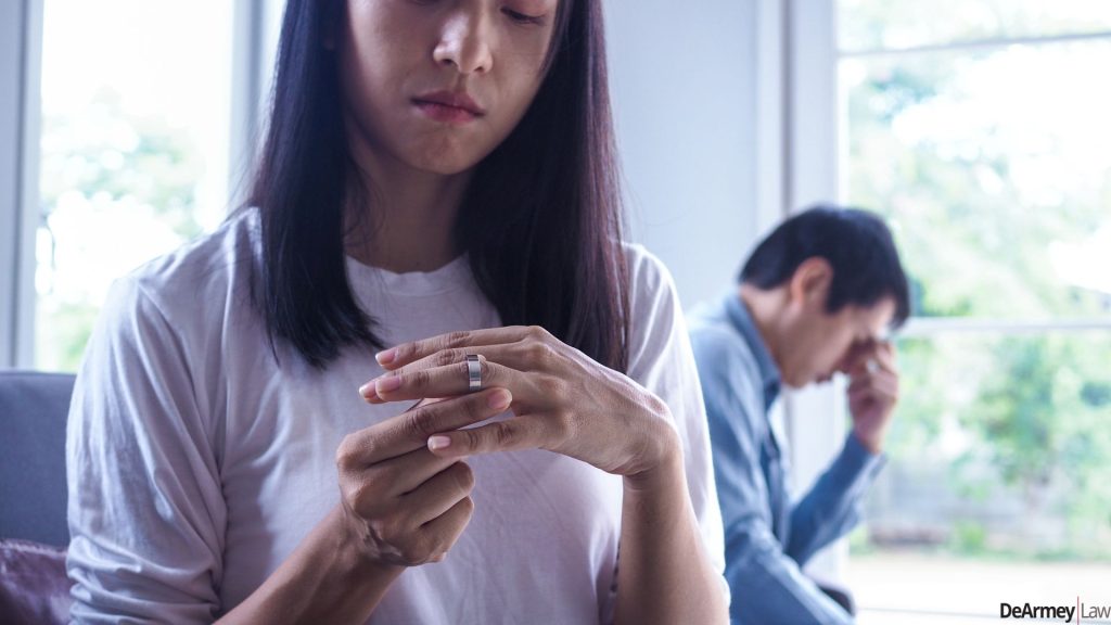 Woman removing her wedding ring.